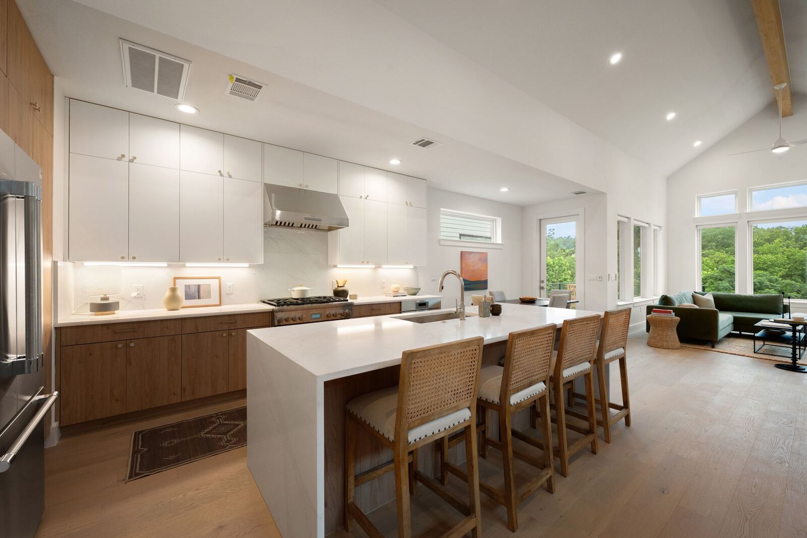 Open kitchen with waterfall island and bar seating